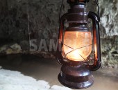 洞窟内で明かりを照らすランプ
