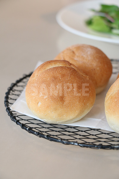 網皿に置かれた丸いパンの写真（縦）